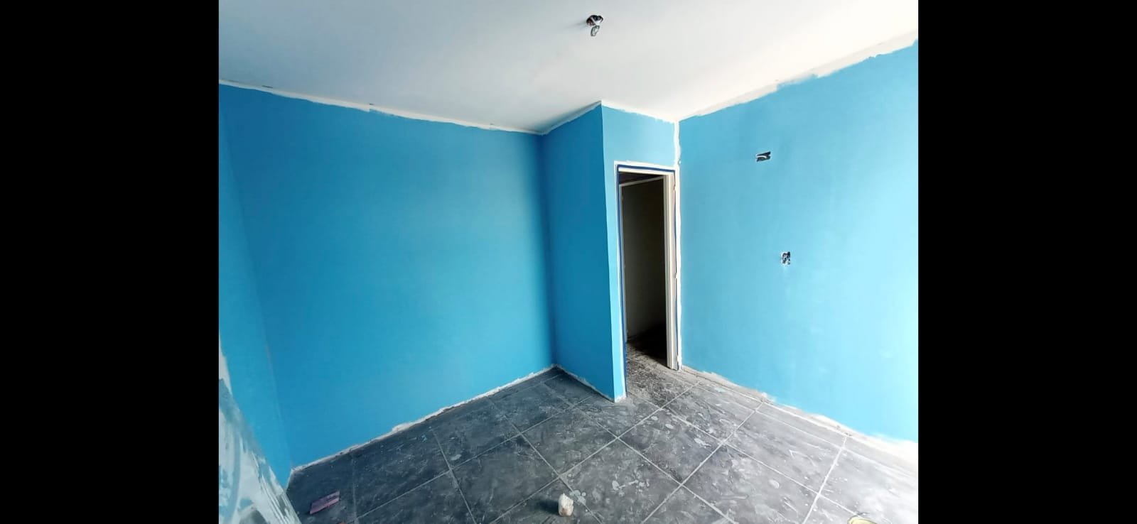 Pintura interior residencial terminada con paredes color azul celeste y cielorraso blanco